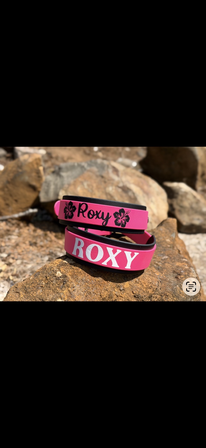Roxy: Pink collars with custom lettering and floral details.